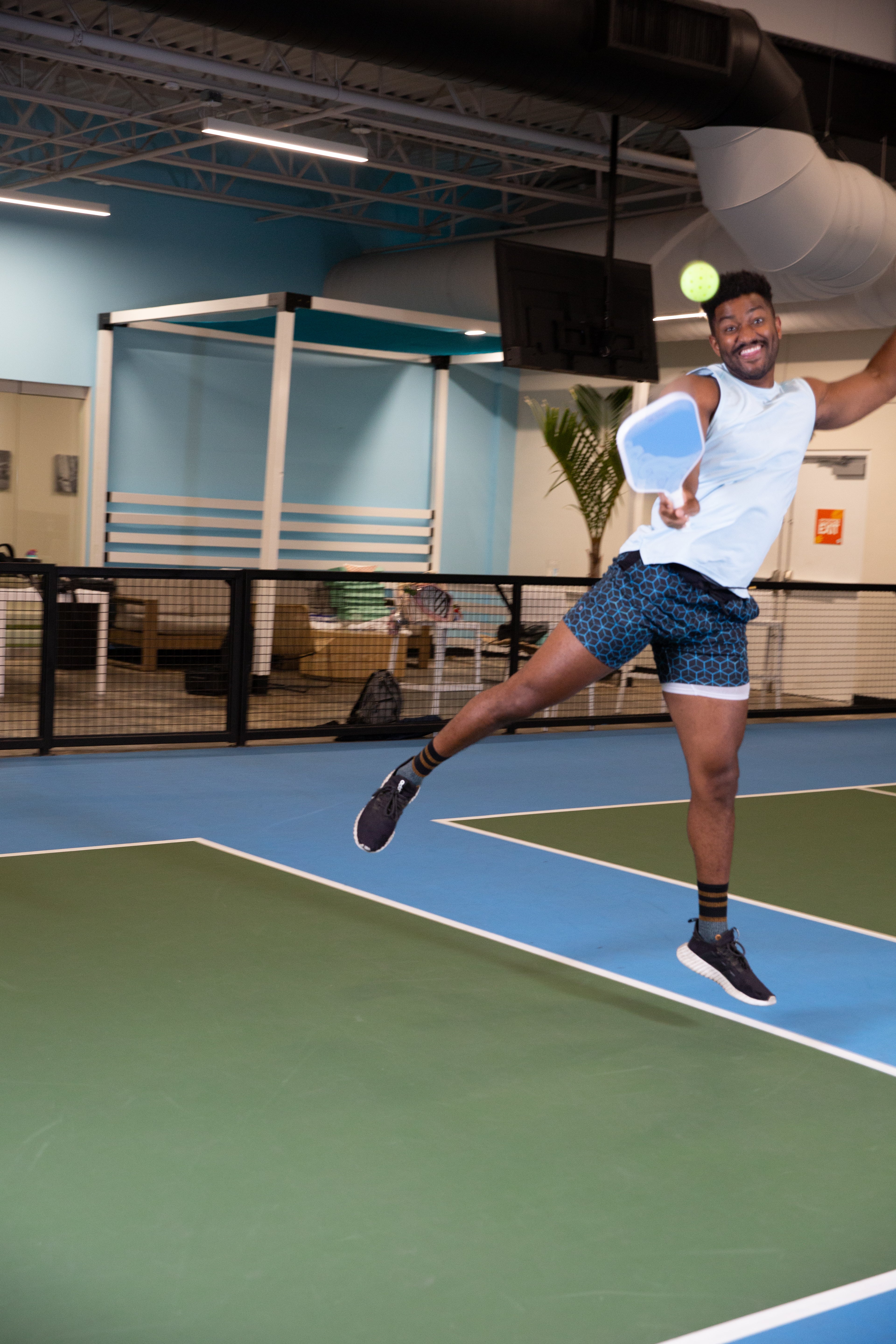 Person playing pickleball on an indoor court