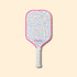 Silly Pickles pickleball paddle with colorful sprinkles pattern on a beige background